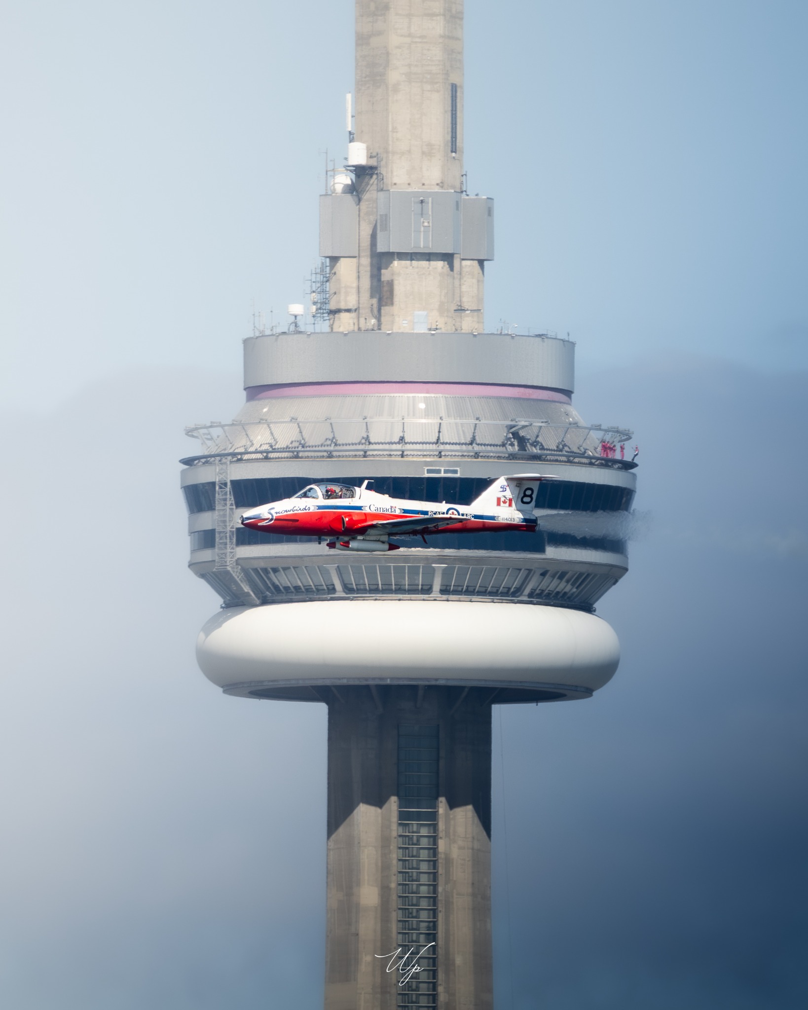 Snowbird Eight flying in front of the CN Tower observation deck